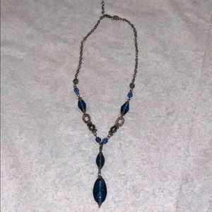 Lia Sophia blue bead necklace on a silver chain.